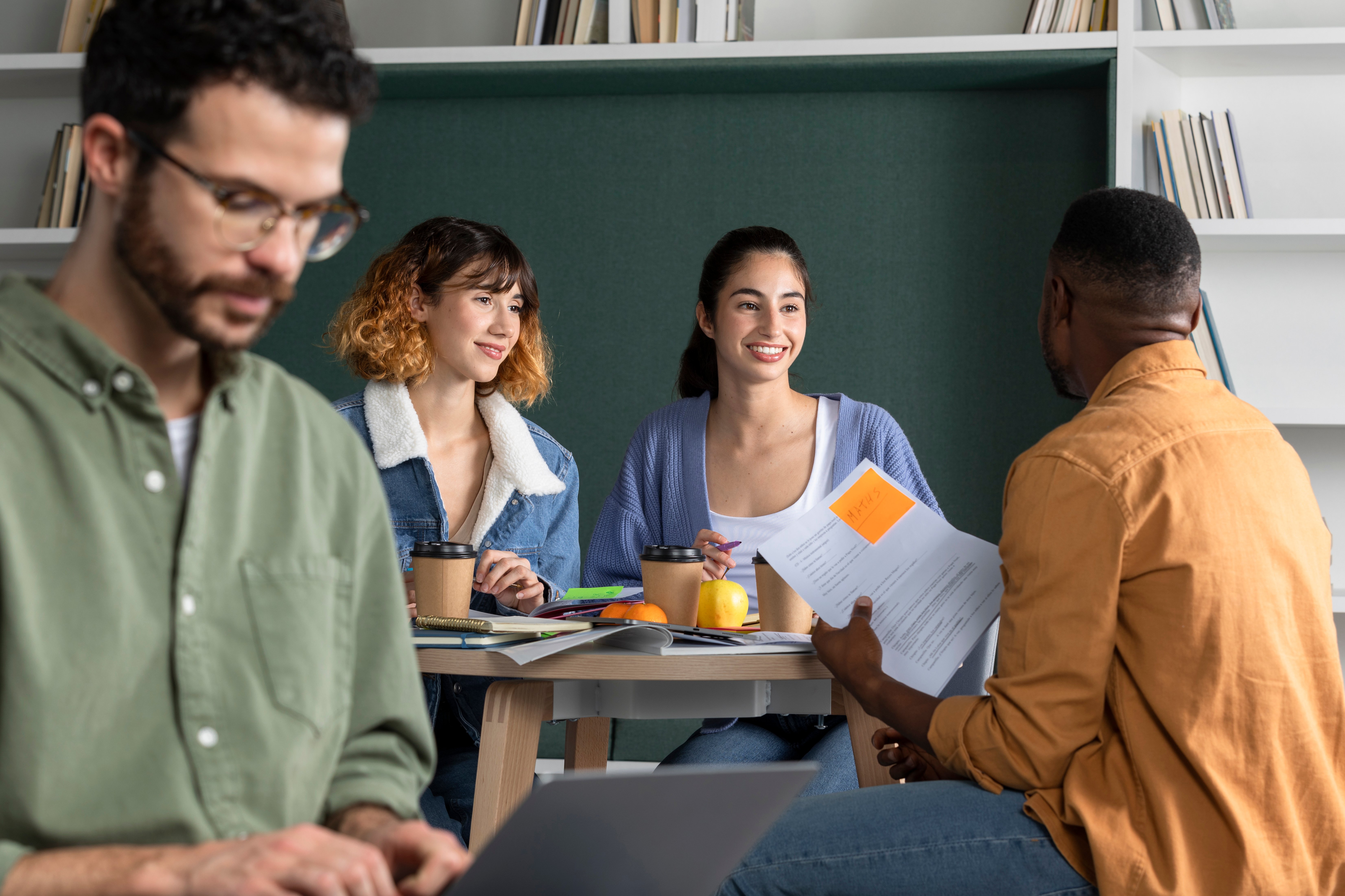 young-man-showing-his-friends-his-notes-study-session